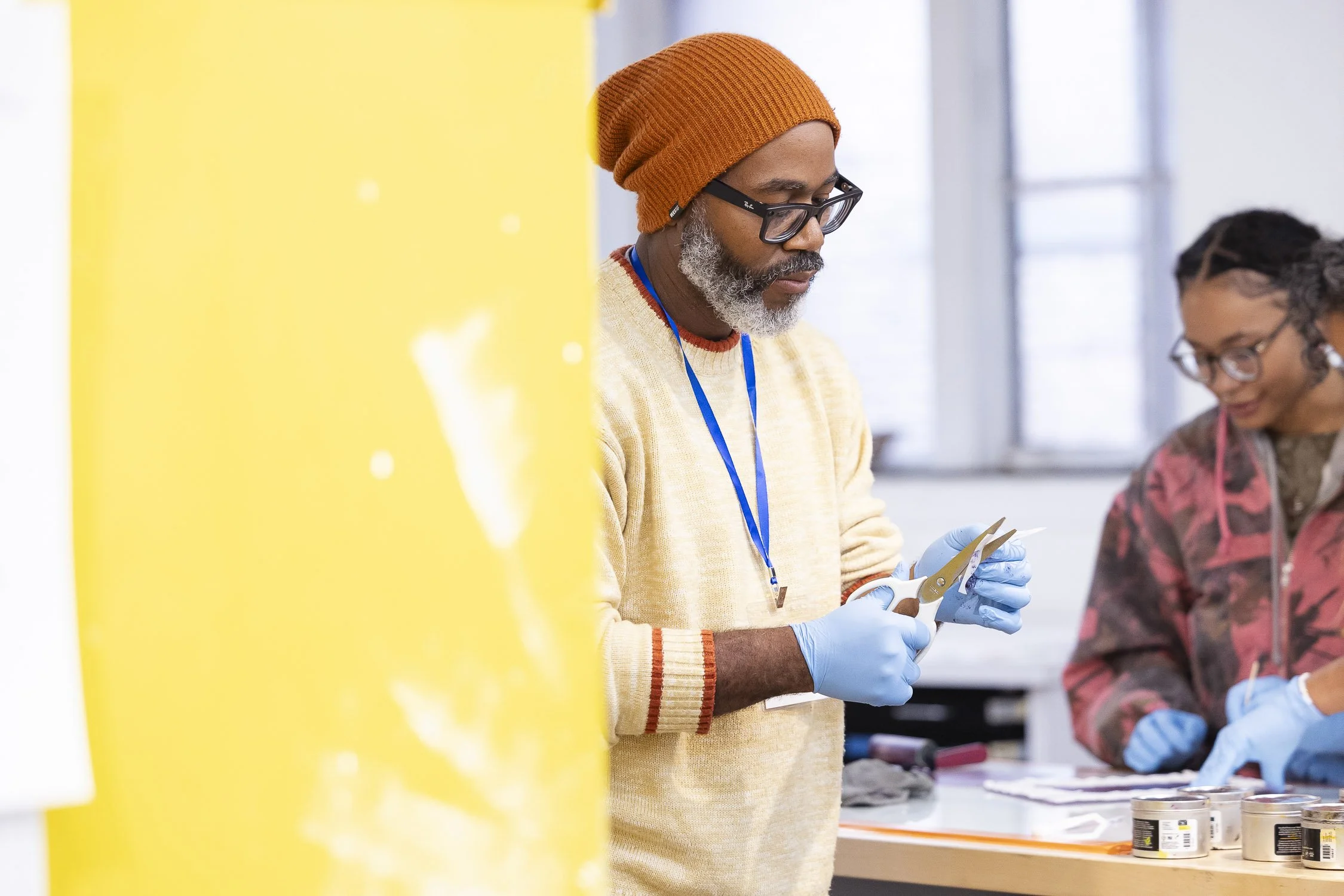 Two people working on an art project during a workshop in Boston.
