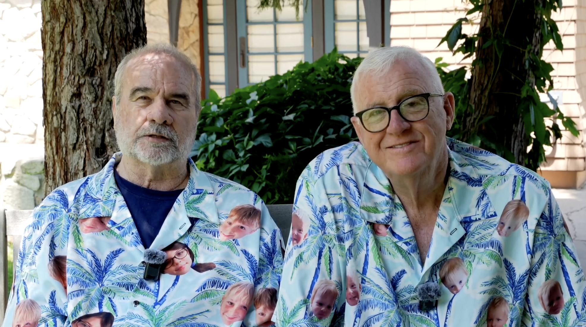 Two grandpas named Drake Larson and Rob Clark, both wearing colorful shirts with pictures of their grandkids on them.
