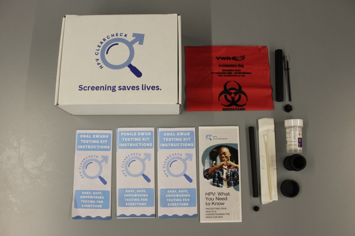 HPV screening kit with instructions, testing tools, and medical supplies arranged on a table.