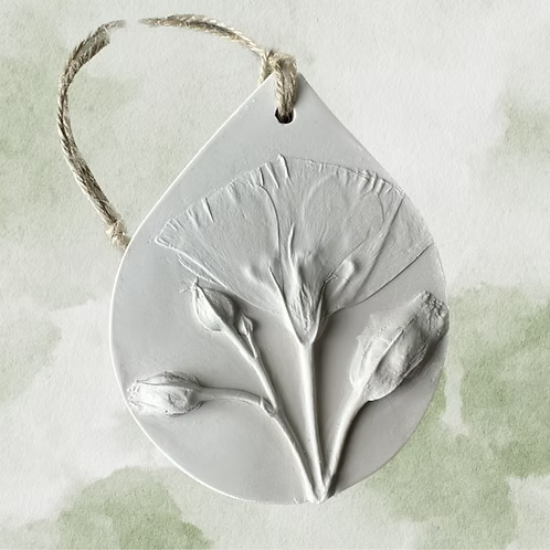 Botanical Bas Relief Essential Oil Diffuser embossed flowers and a jute string for hanging.