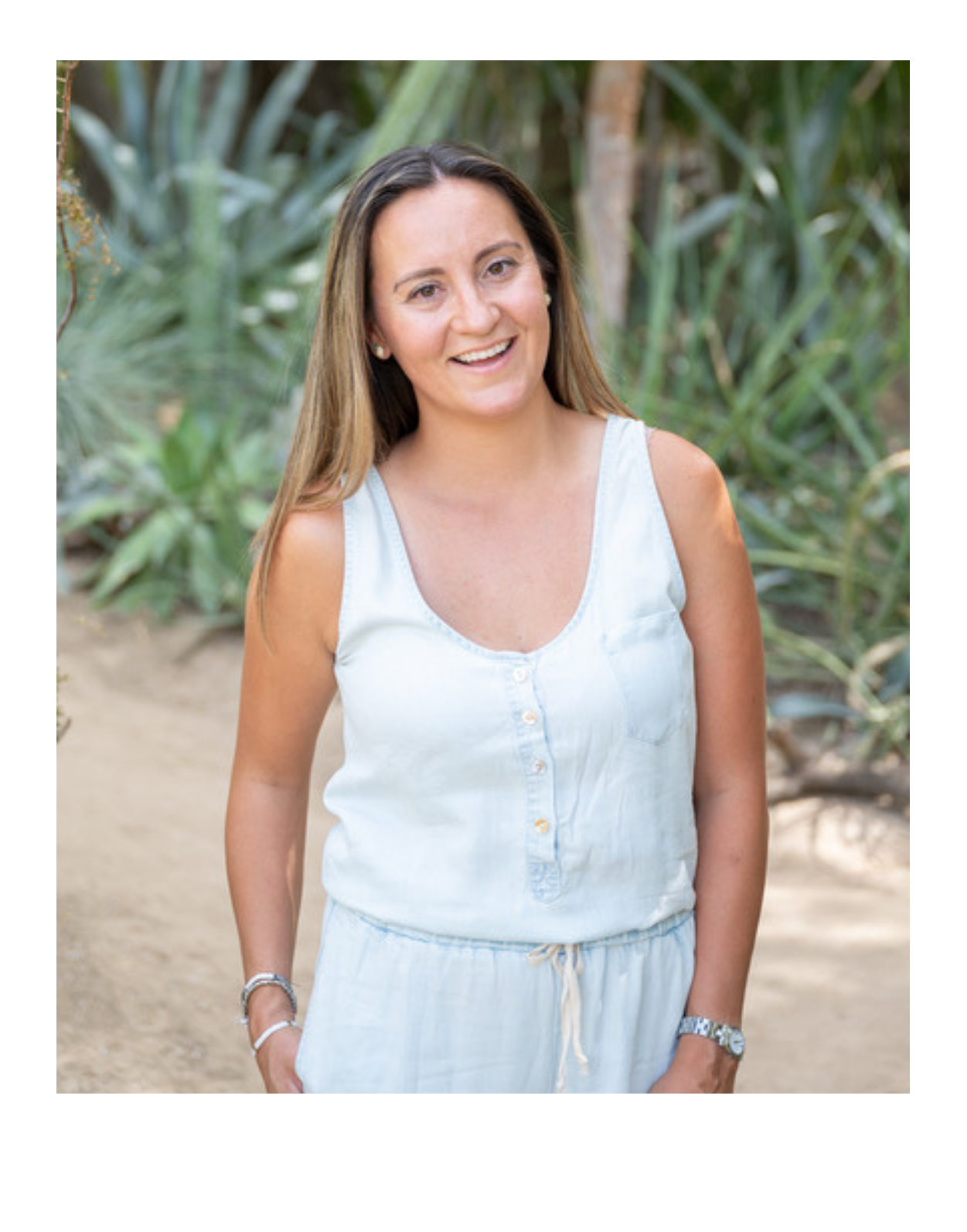 Pam Phelan, Summerville therapist, standing outdoors smiling with greenery behind her
