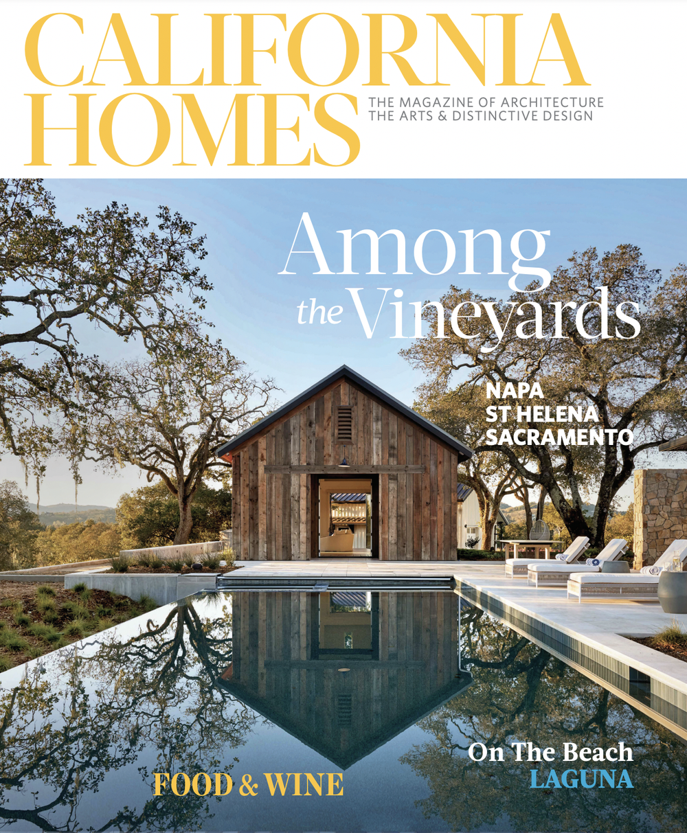 Cover of California Homes magazine featuring a rustic house by a reflecting pool, trees, and outdoor lounge chairs.