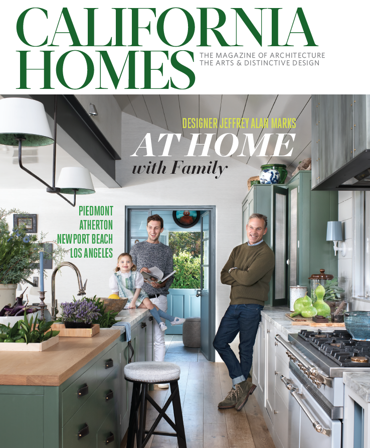 Family of three in a modern kitchen with green cabinets, natural light, and decorative plants, smiling and spending time together.