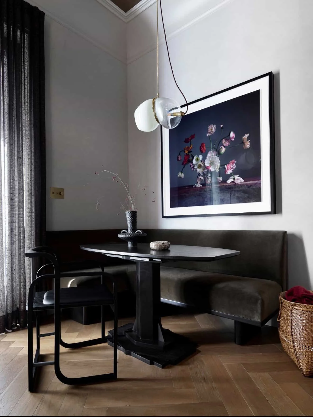 Modern dining room with a large marble table, 10 upholstered chairs, wooden beams, floor-to-ceiling windows with mountain and forest view, and TwentyTwo Brightbound studio-blown architectural lighting fixture.