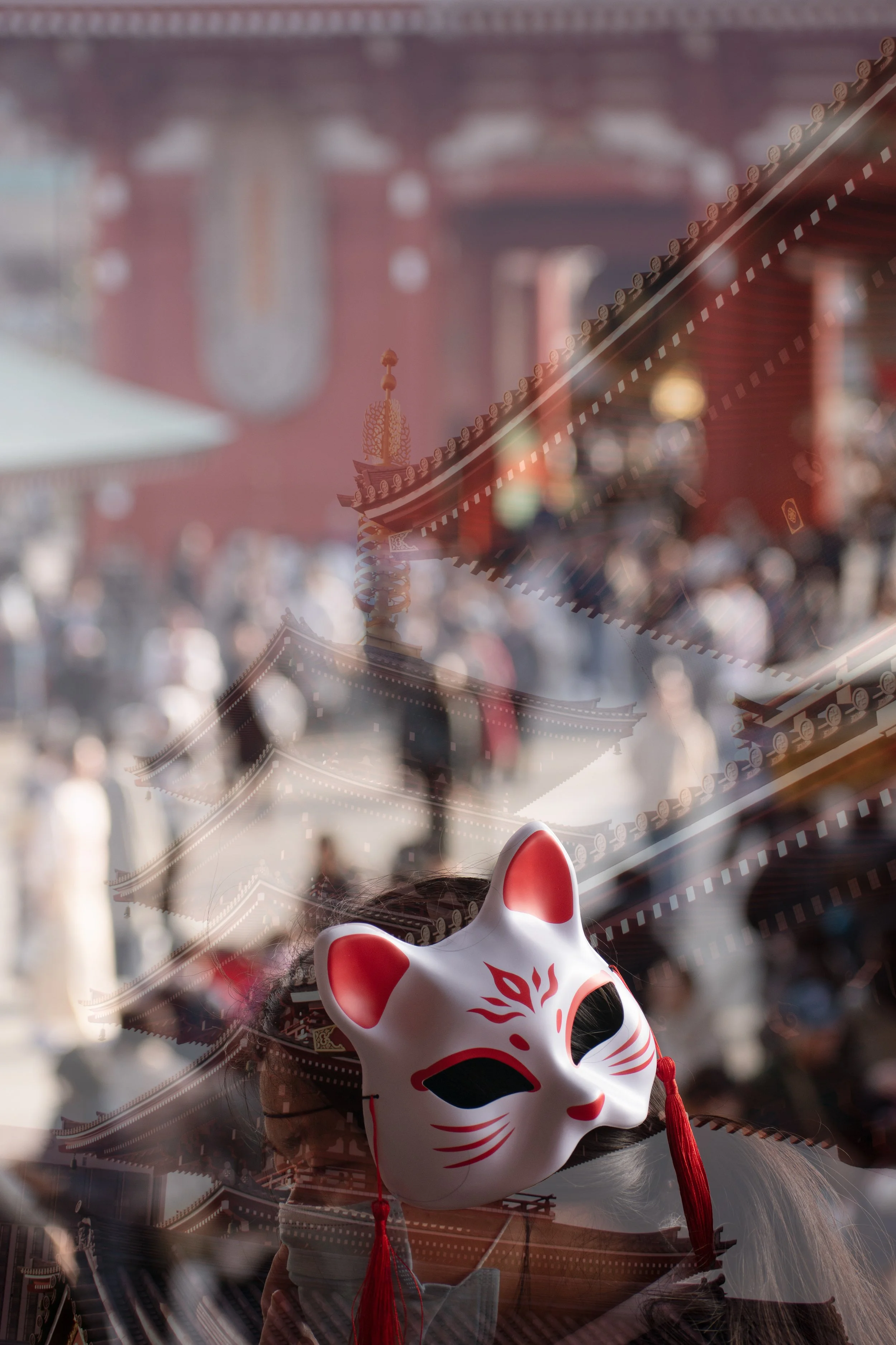 Japan double exposure film photo of woman with a kitsune mask overlaid with diagonal front exterior of Japanese temples.