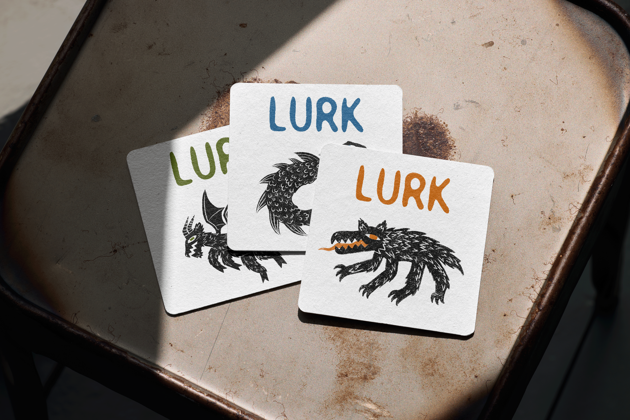 LURK coasters depicting folk stylized Chupacbra, Lochness monster, and jersey devil