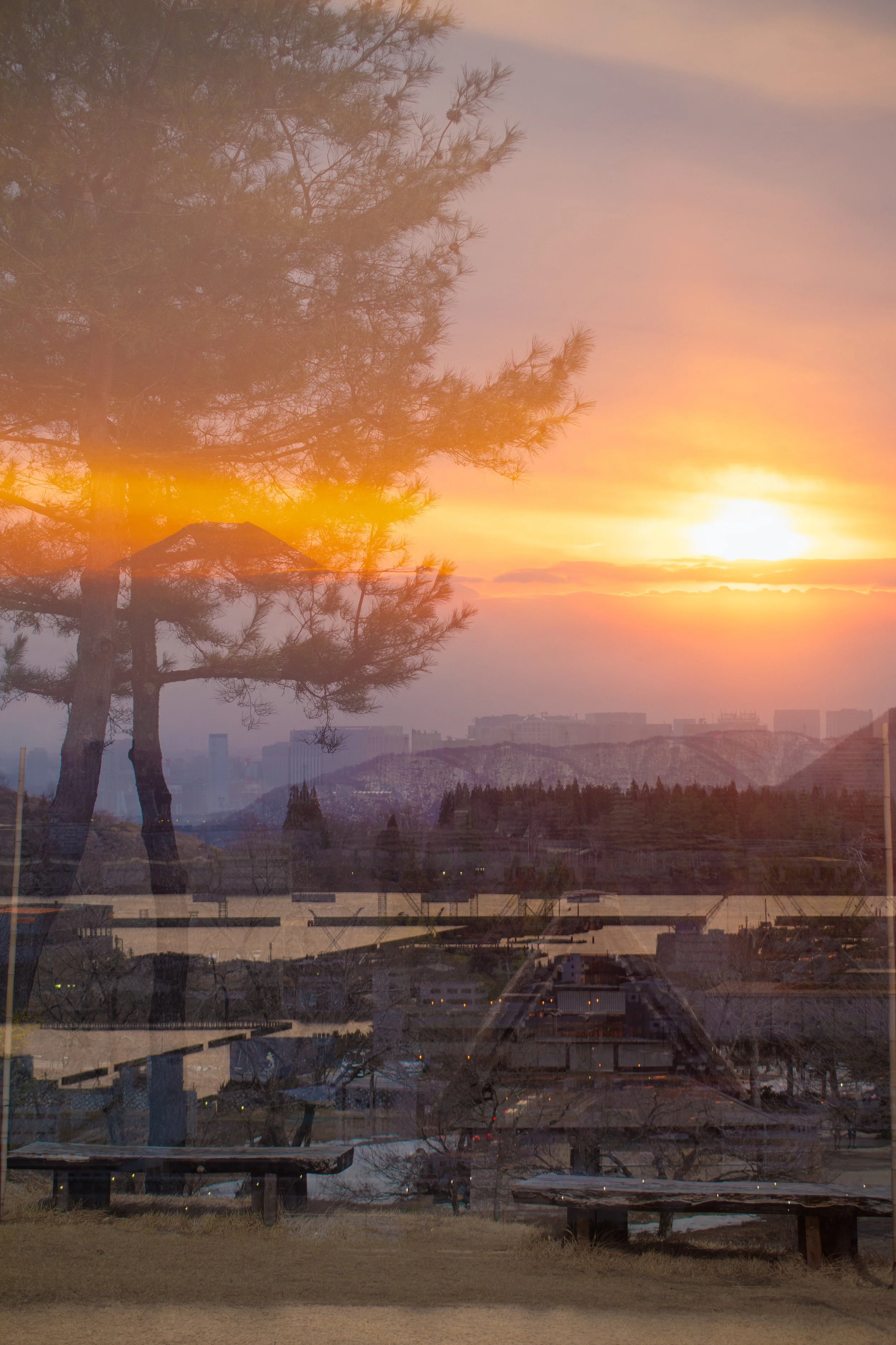 Japan double exposure photo of hilltop view of japan overlaid with sunset.