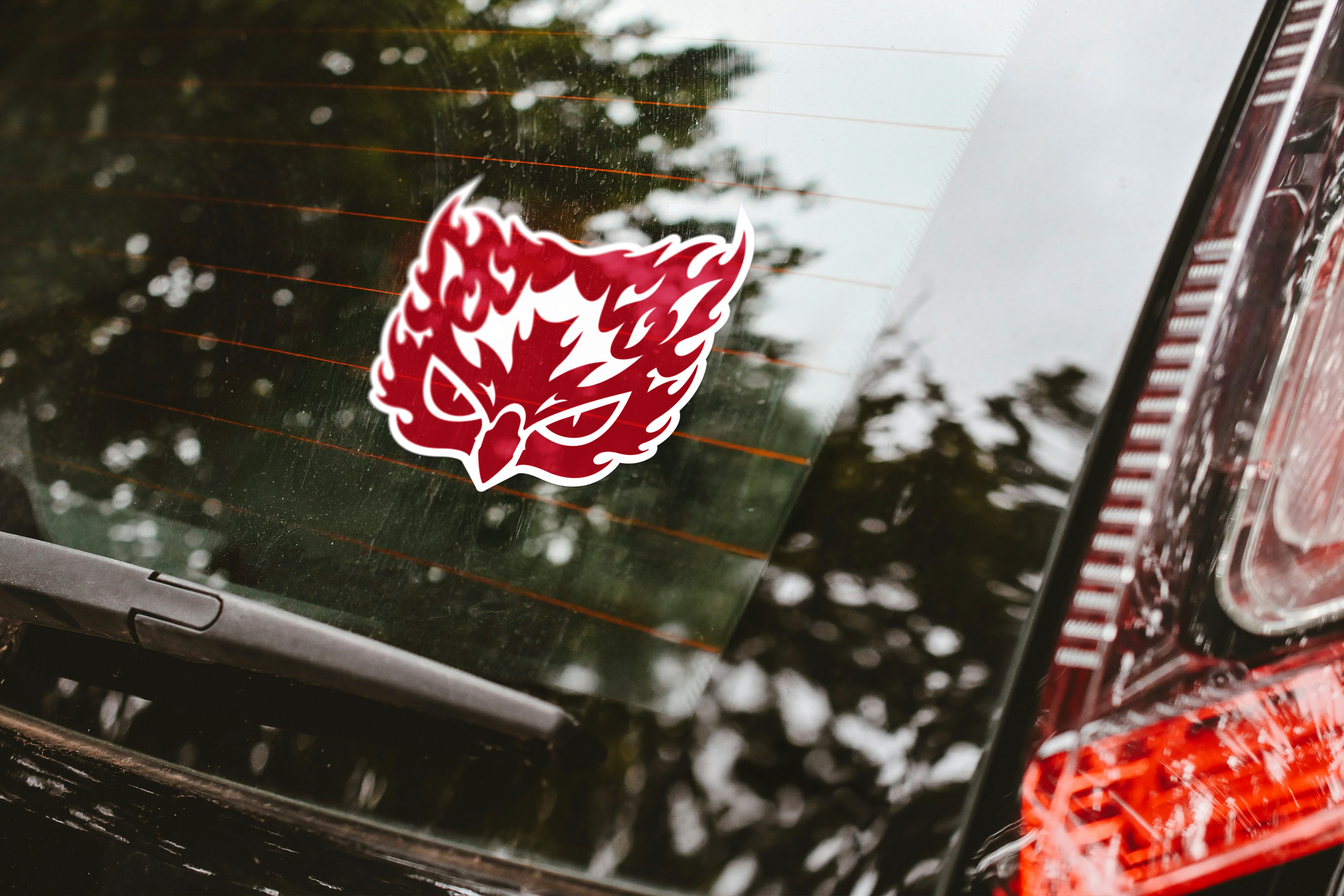 Temple owl sticker on back windshield with flaming silhouette
