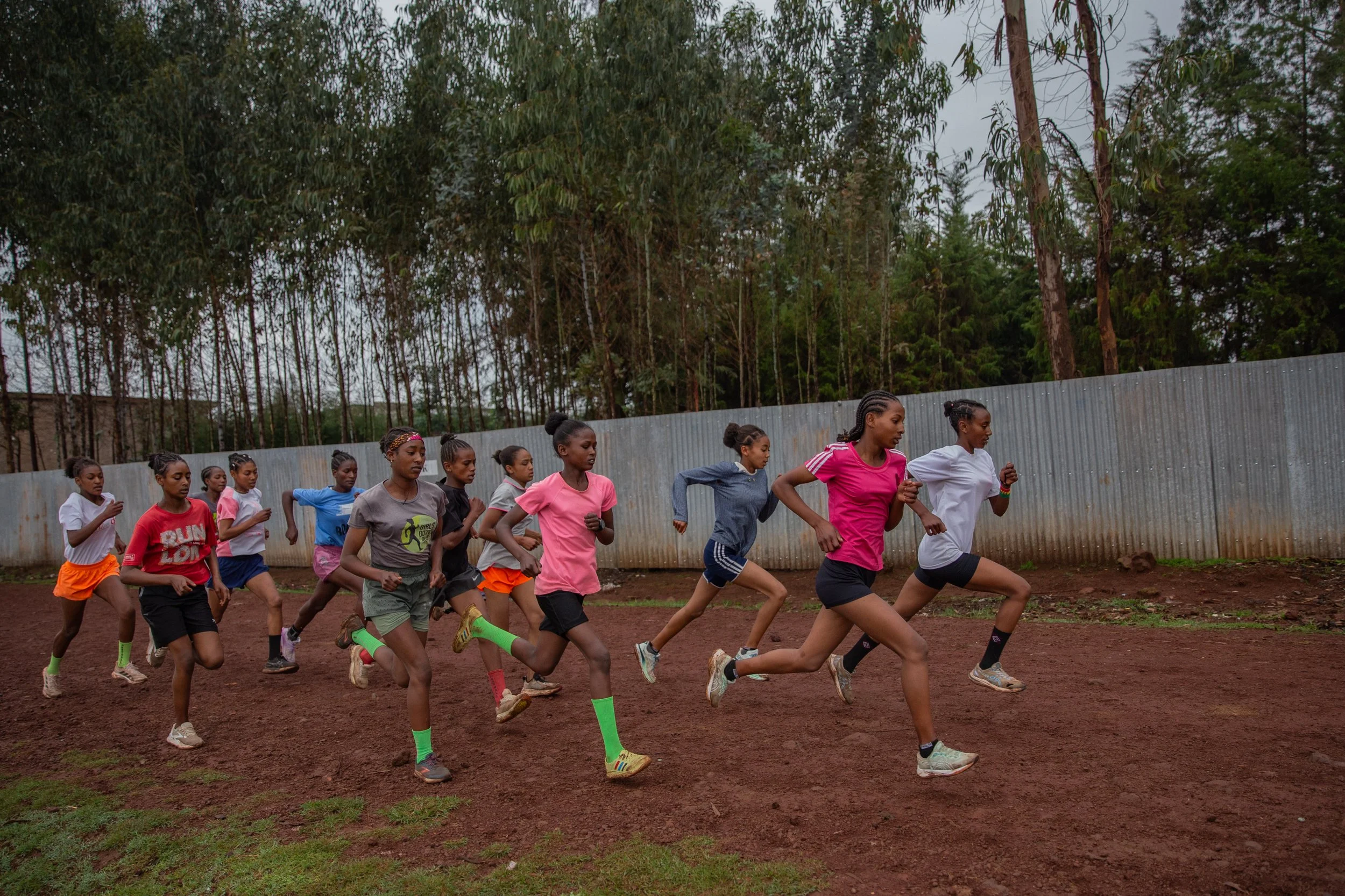 Ethiopian teen girls running fast as a group on track