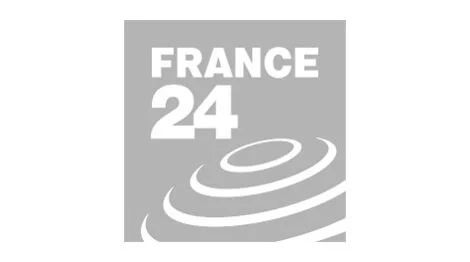Logo of France 24, a news channel, featuring the text "FRANCE 24" and a stylized spiral design.