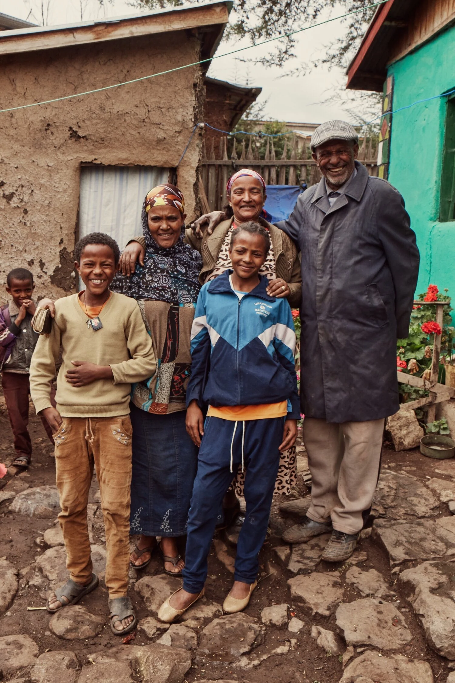 Girls Gotta Run family of 5 standing in town outside a house