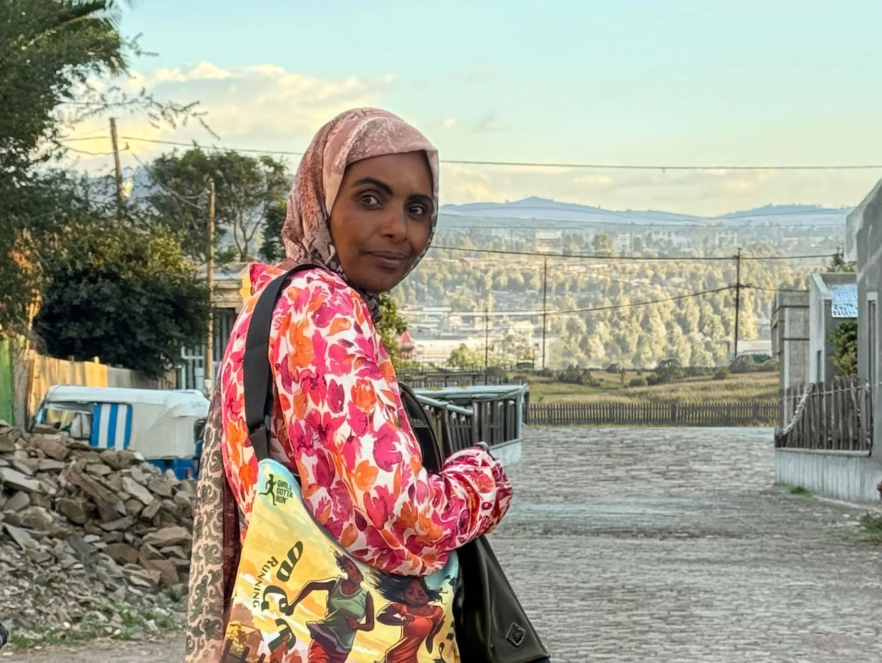 Portrait photo of Sukuare Nure smiling with Ethiopian hills in the background