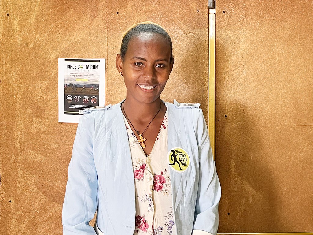 Portrait of Coach Amsal smiling in the Girls Gotta Run program office