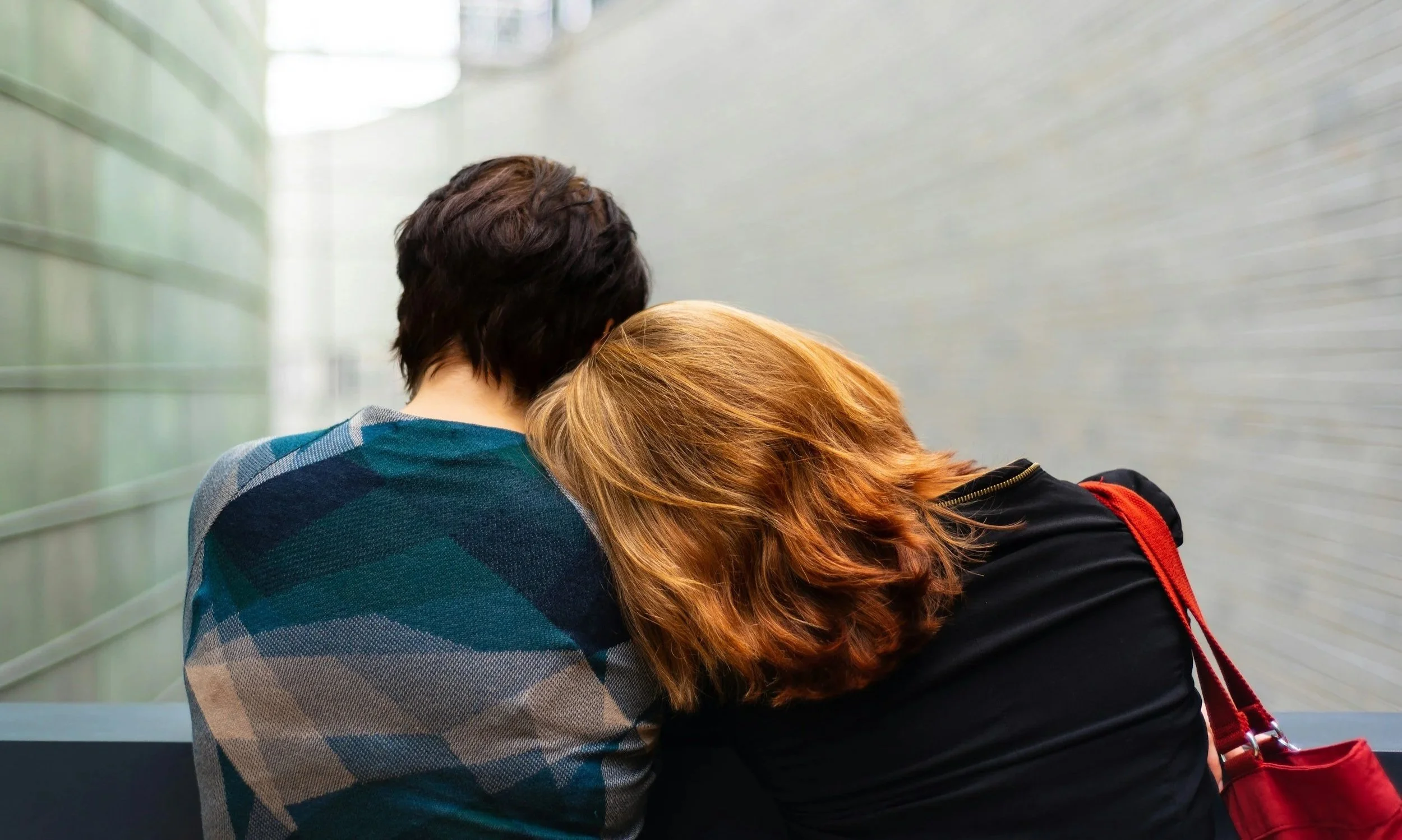 Mother's head on her child's shoulder