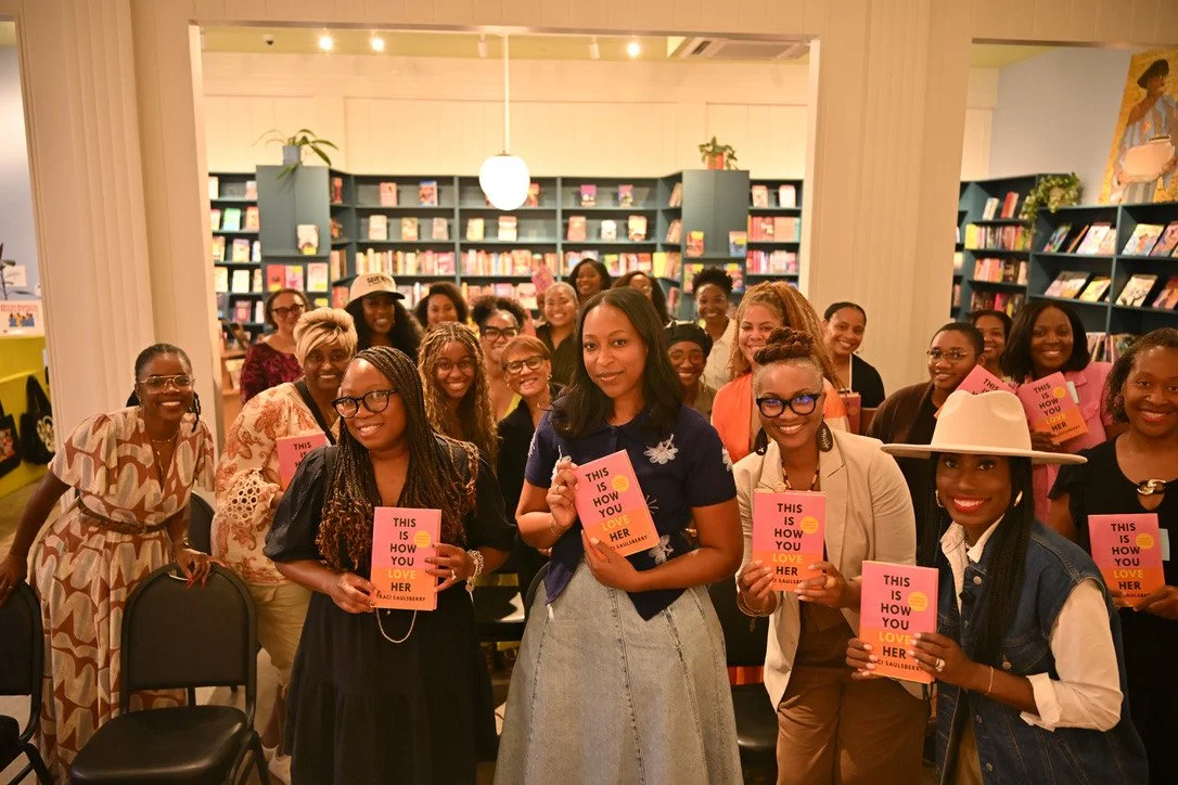 A room full of readers holding This Is How You Love Her with Traci at Kindred Stories