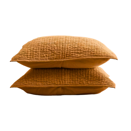 Two stacked brown textured pillows against a black background.