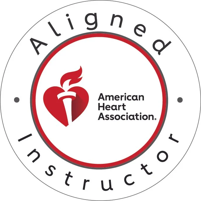 An American Heart Association logo with a red heart and torch symbol, surrounded by the words 'Aligned Instructor' in a circular layout.