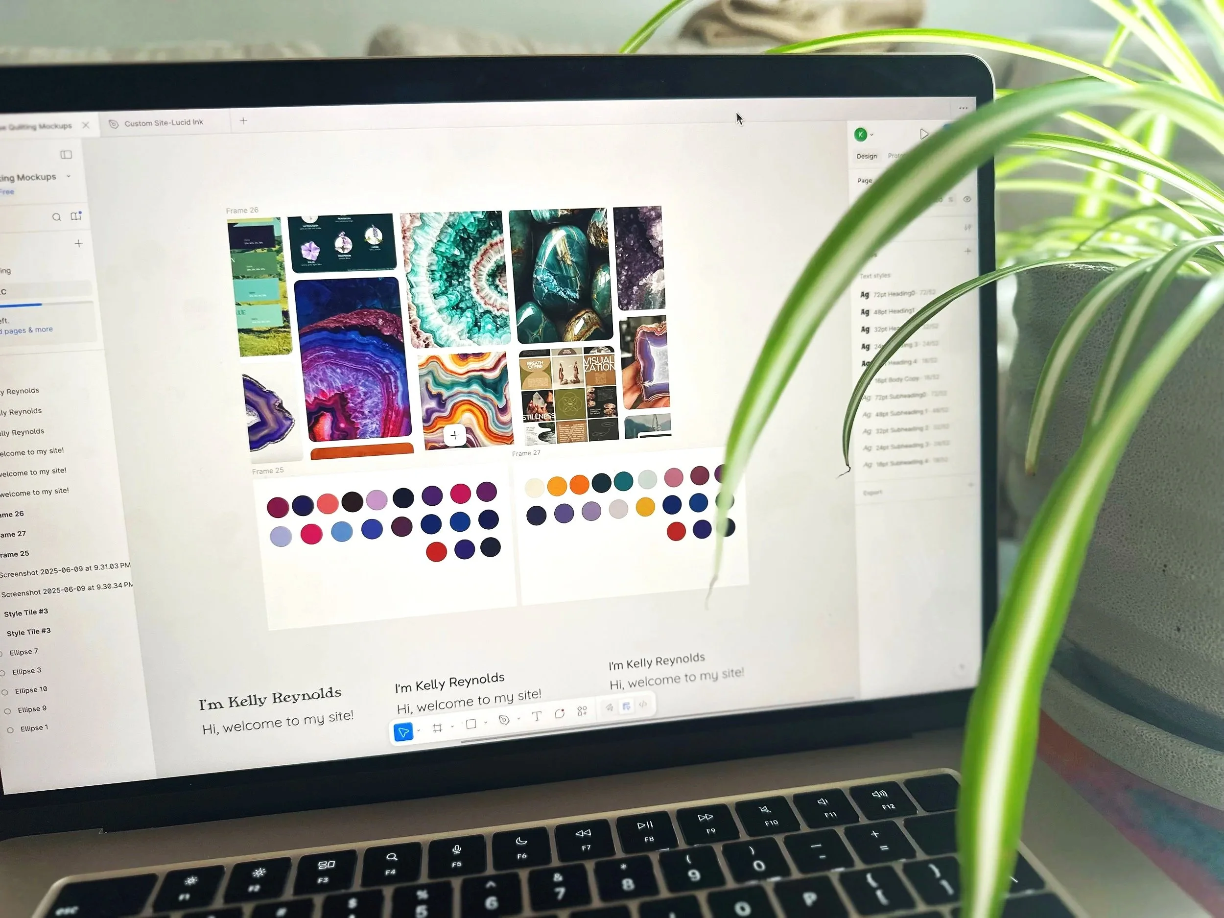 A laptop screen displaying a website with colorful abstract images, color palettes, and text that reads 'I'm Kelly Reynolds. Hi, welcome to my site!'. Green plant leaves are partially obstructing the right side of the screen.