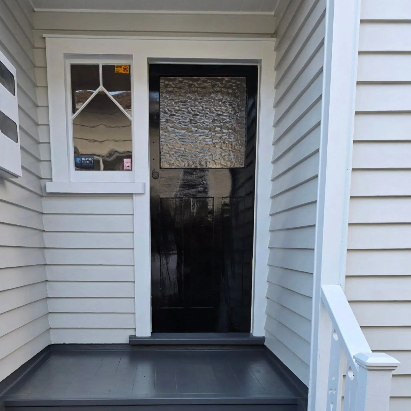 From faded and weathered to bold and timeless.

This old stained front door had lost its life after years of wear and sun exposure. After the prep work and a full high gloss black finish, it&rsquo;s now a standout feature that completely changes the 