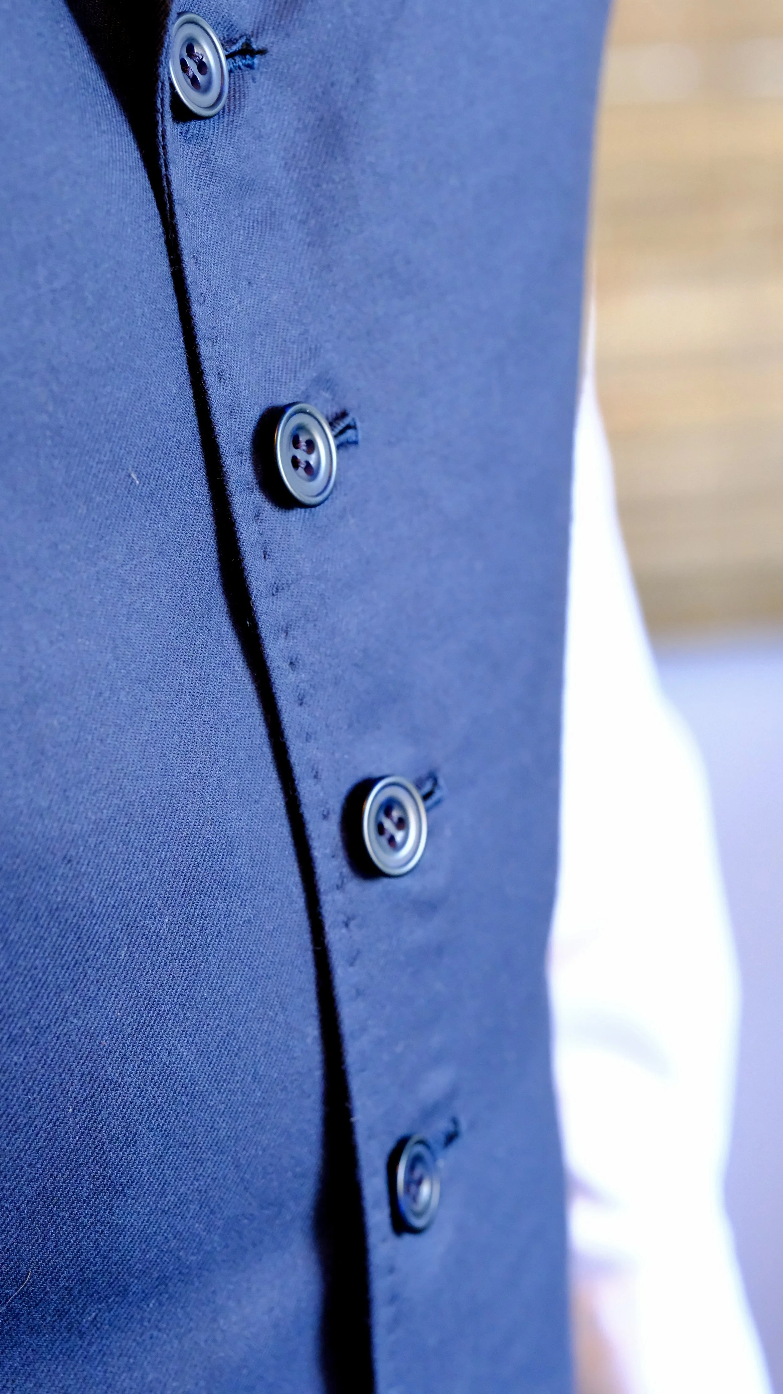 Close up photo of bespoke vest stitching and buttons