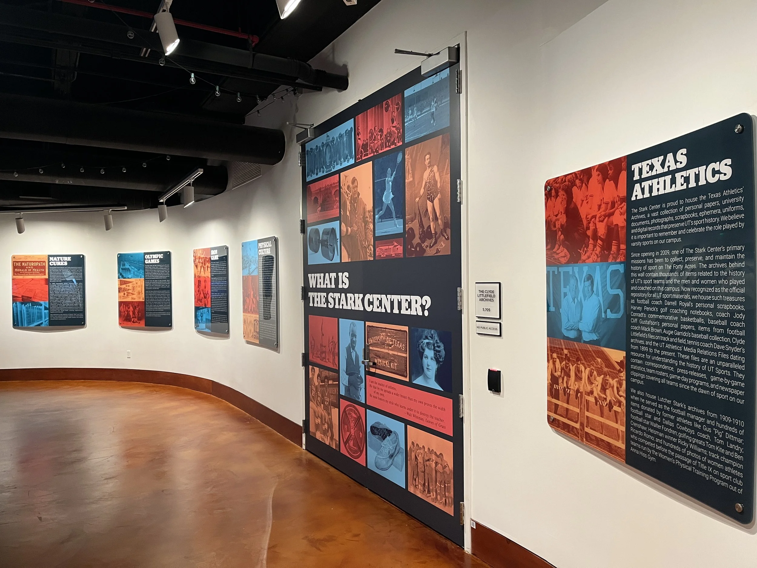 Exhibit hall with informational panels on the history of Texas athletics, including a prominent panel titled "TEXAS ATHLETICS" with detailed text about the university's sports history and archives.