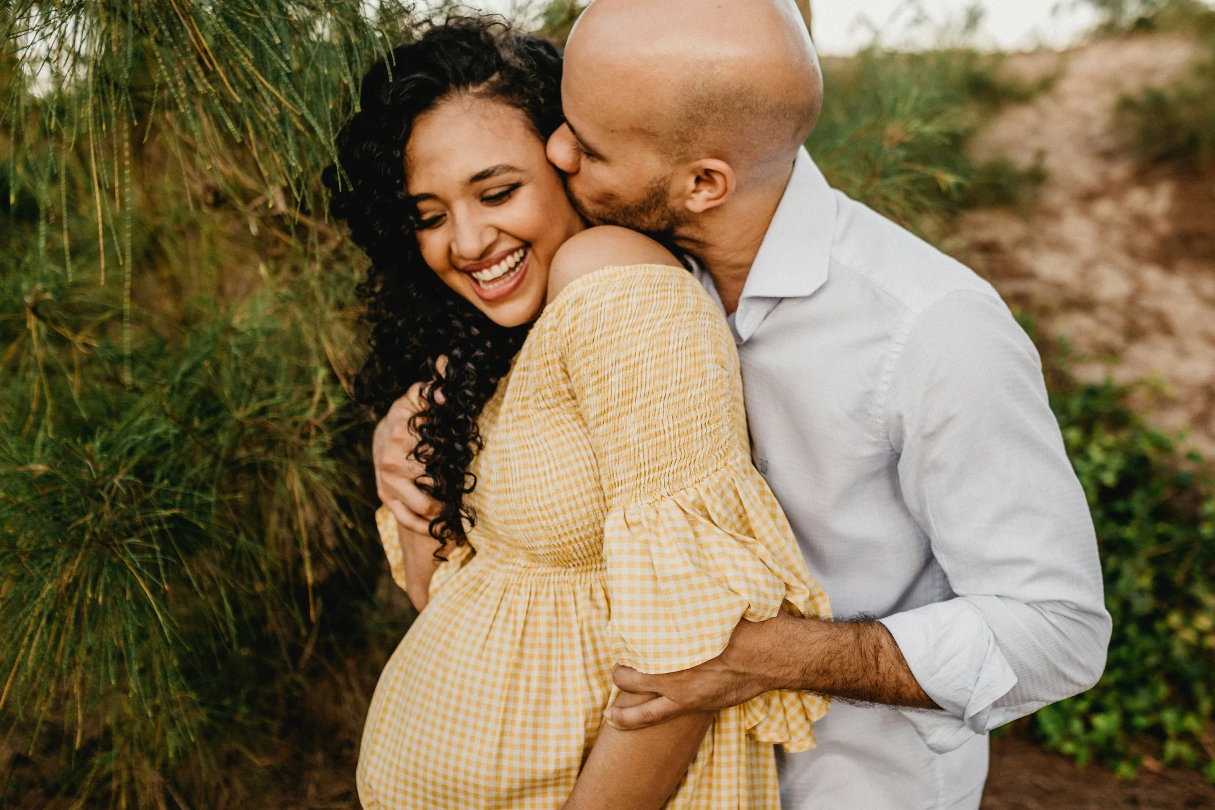 Happy couple embracing outdoors — perinatal and pregnancy chiropractic care at Rhythm Health Santa Cruz