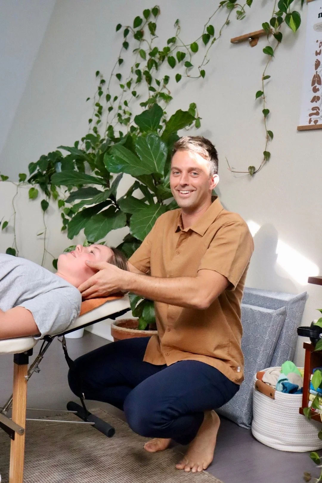 Dr. Joe Thompson performing a gentle neck adjustment on an adult patient — holistic wellness chiropractic care for stress and nervous system regulation at Rhythm Health Santa Cruz