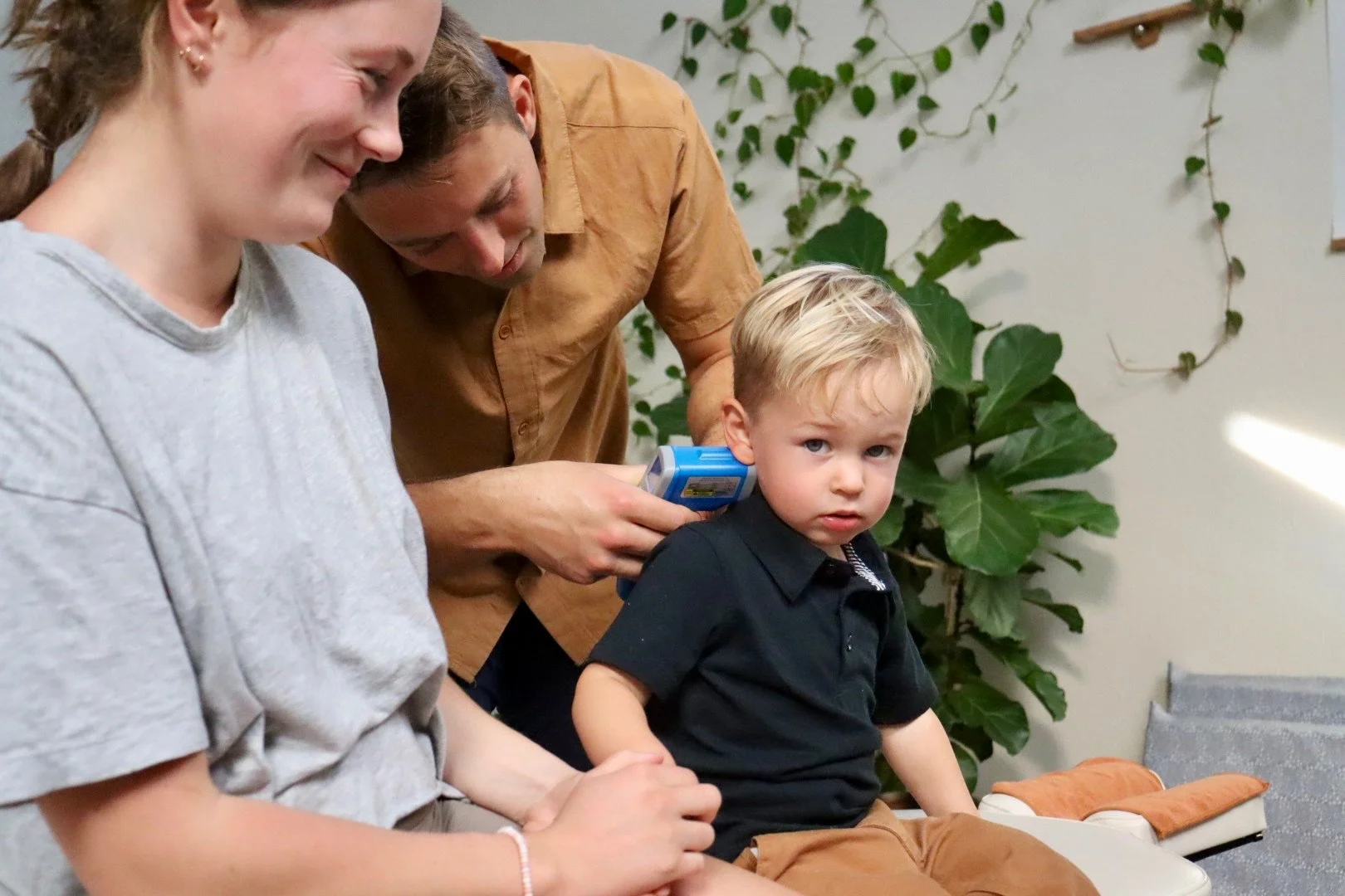Chiropractor performing gentle adjustment on a toddler — pediatric chiropractic care at Rhythm Health Santa Cruz