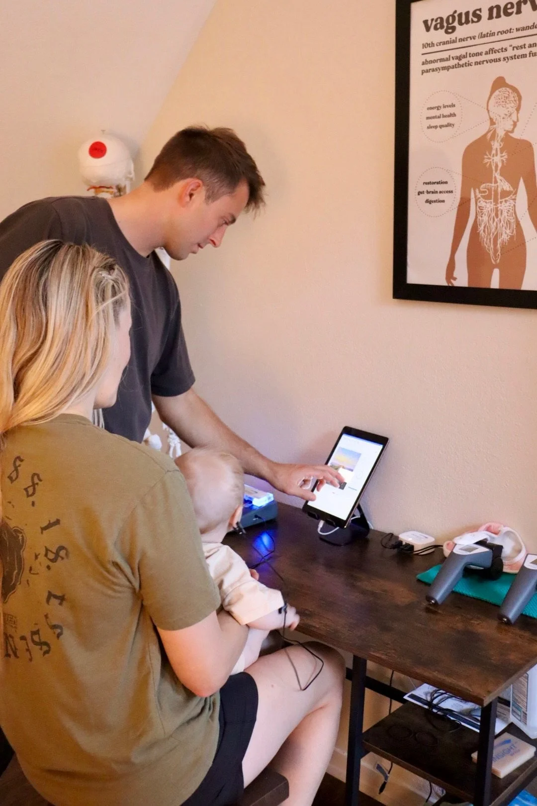 Dr. Joe Thompson performing an INSiGHT nervous system scan on a perinatal patient at Rhythm Health Santa Cruz