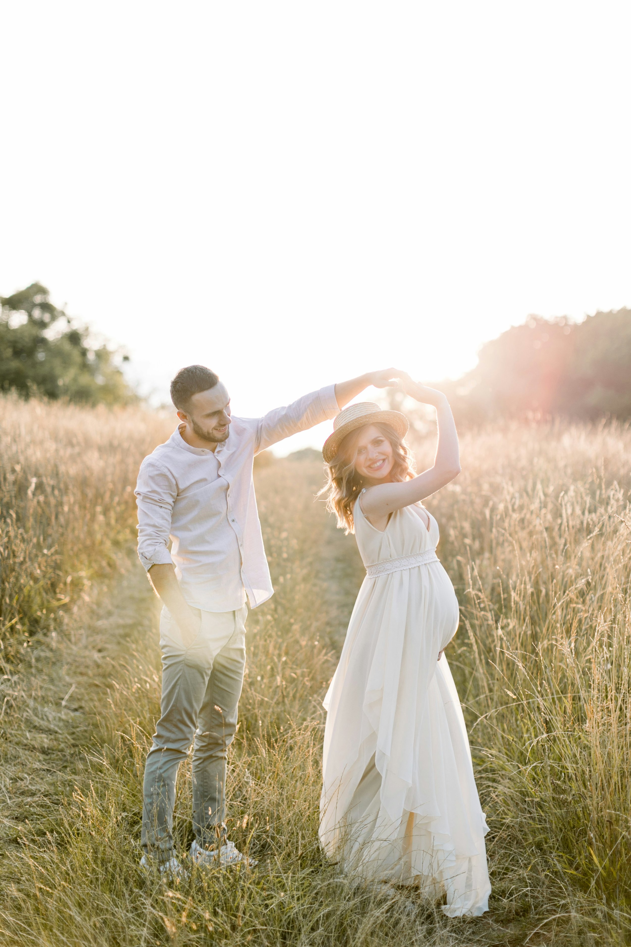 Happy couple dancing in a field — perinatal chiropractic care for conception, pregnancy, and postpartum at Rhythm Health Santa Cruz