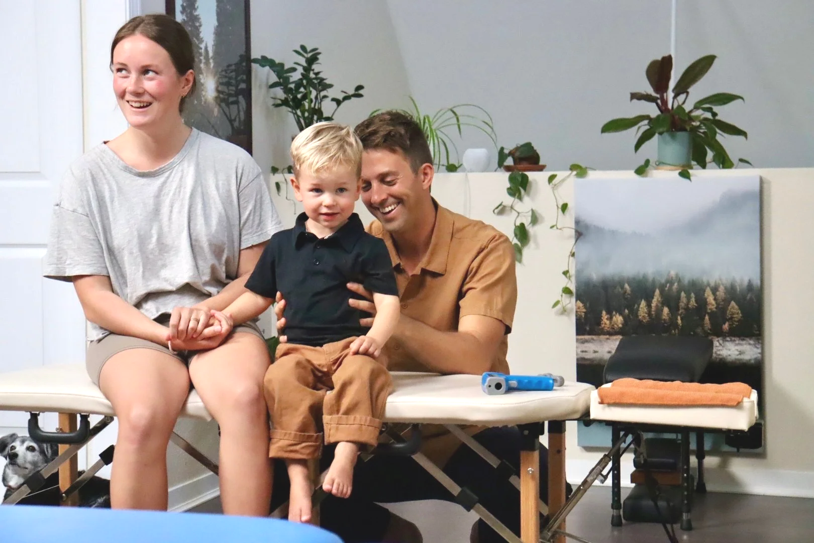 Dr. Joe Thompson smiling with a young pediatric patient at Rhythm Health & Performance in Santa Cruz