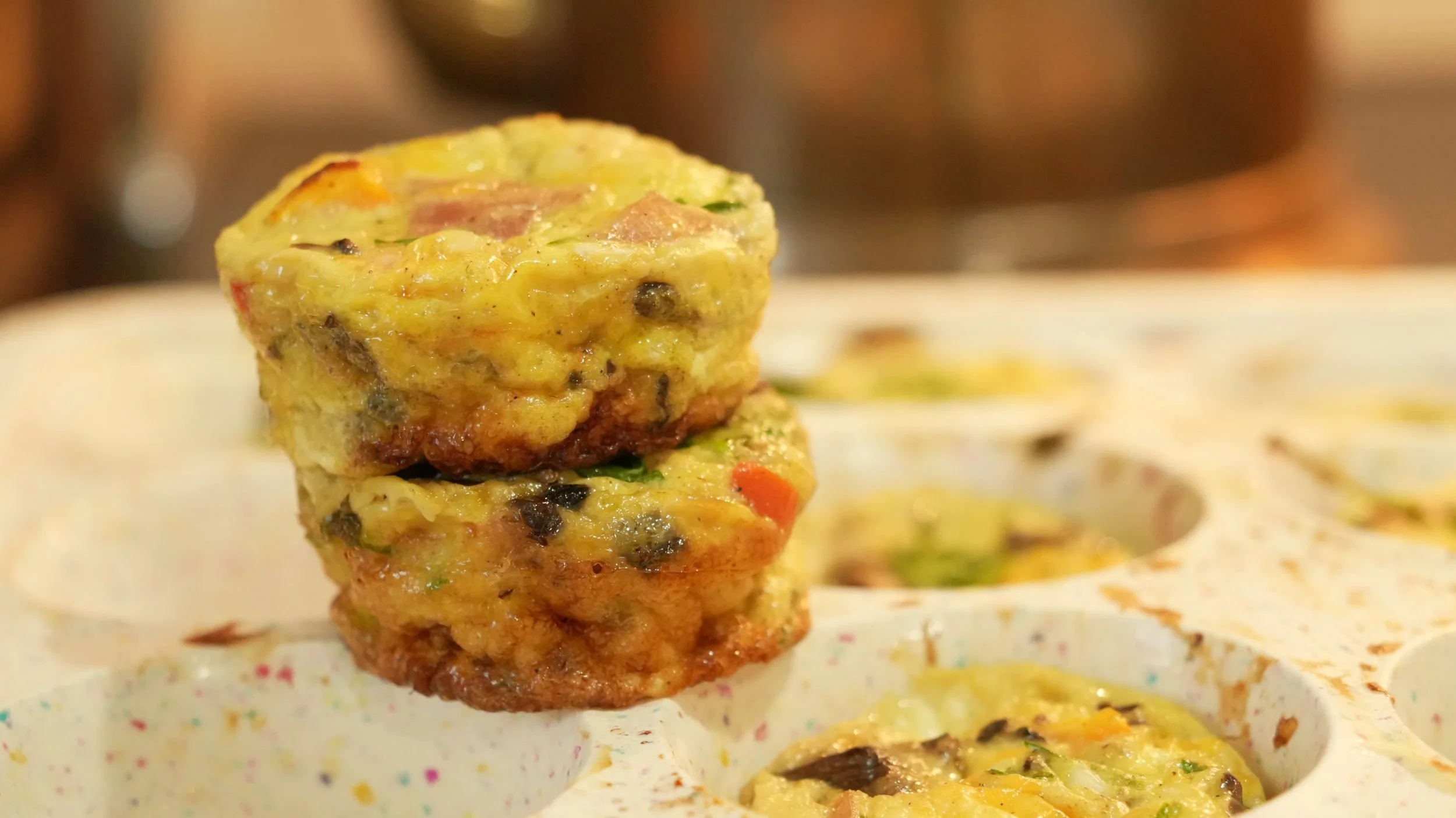 Healthy egg muffins loaded with spinach, peppers, mushrooms, ham, and greek yogurt