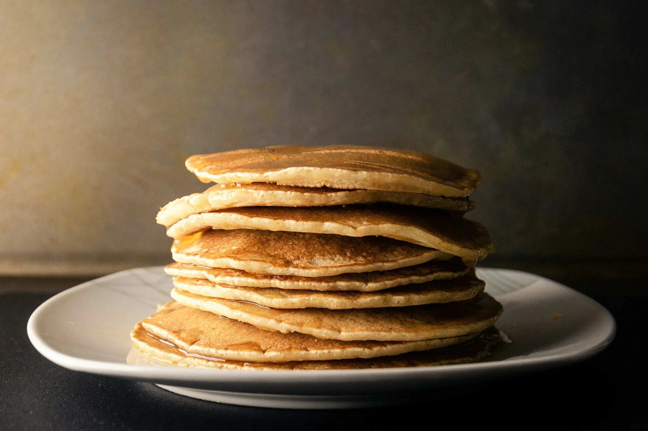 Stack of buttermilk pancakes on a white plate