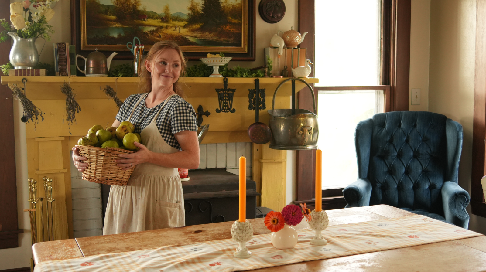 woman holding basket of green pears in dinning room