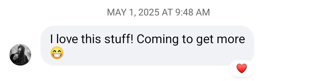 Screenshot of a text message reading 'I love this stuff! Coming to get more' accompanied by a smiling emoji, and a small red heart emoji beneath.