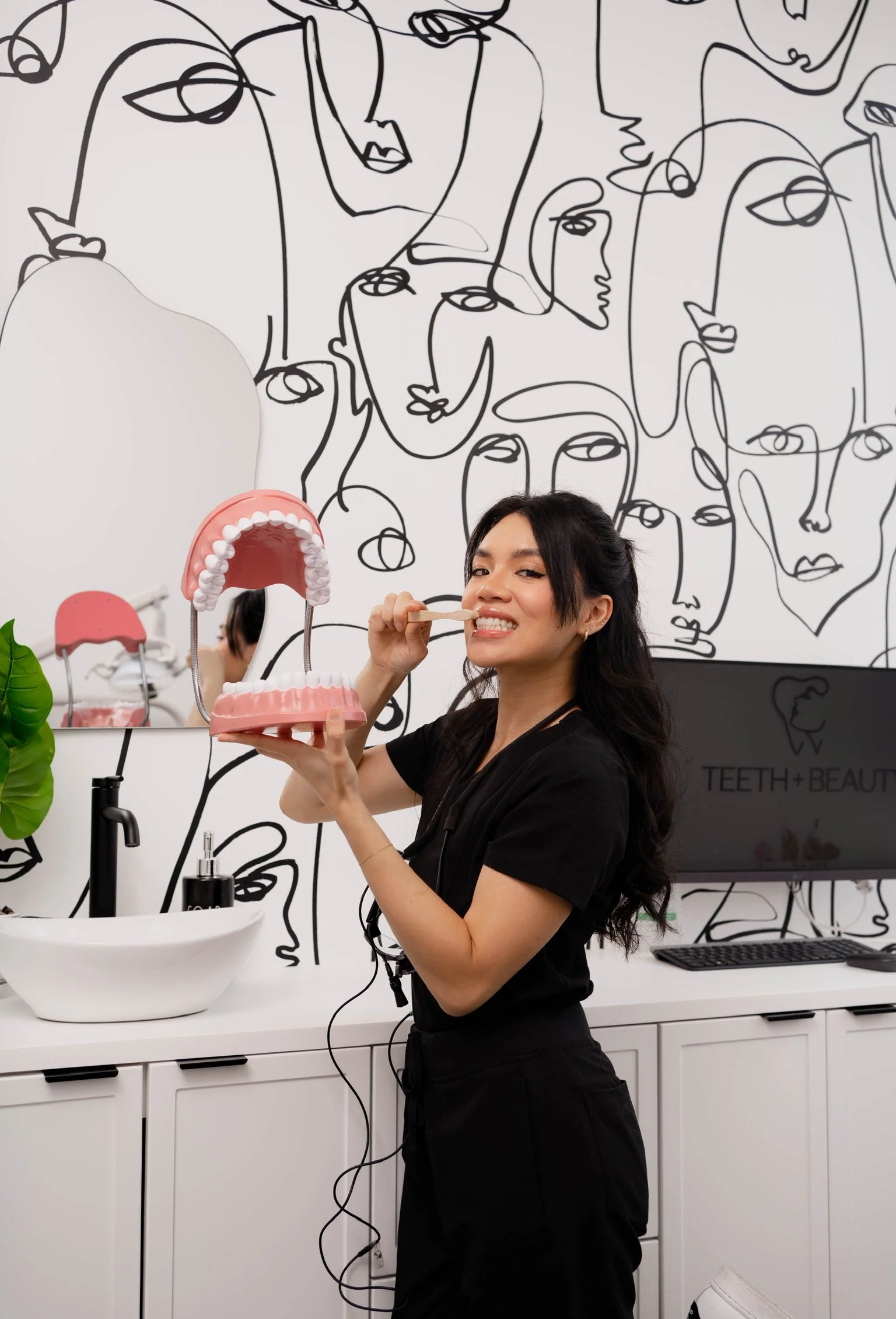 Gum contouring explained by dentist using dental model at Teeth & Beauty dental clinic in Toronto.