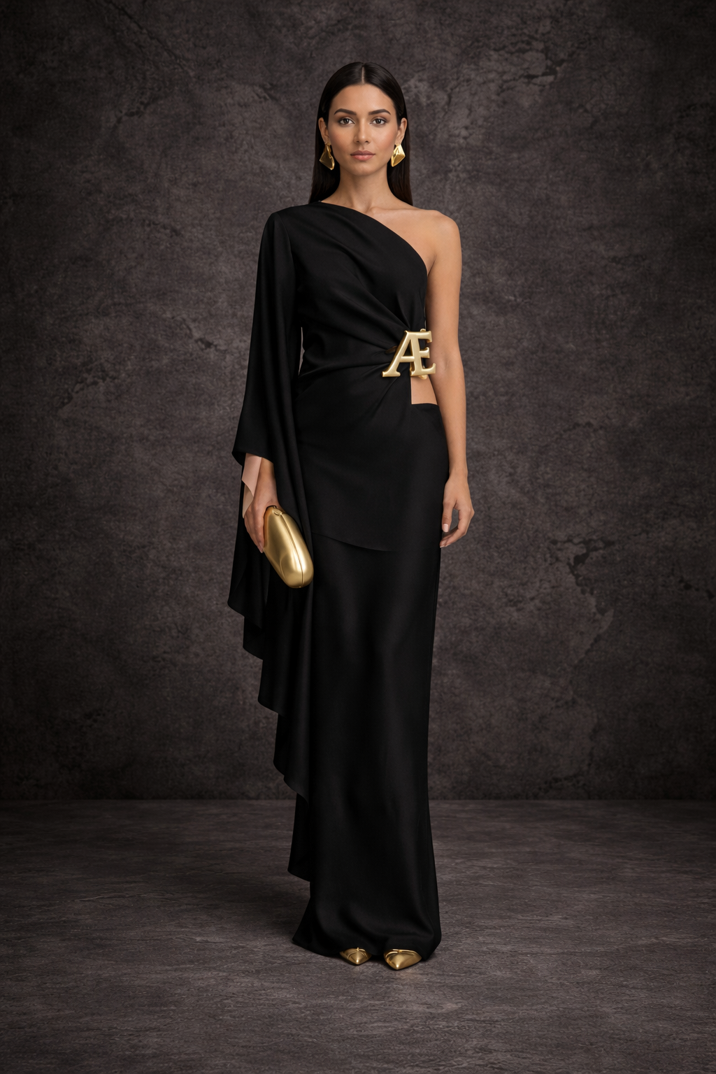 Woman in a black evening gown with gold accessories, standing against a dark textured background.