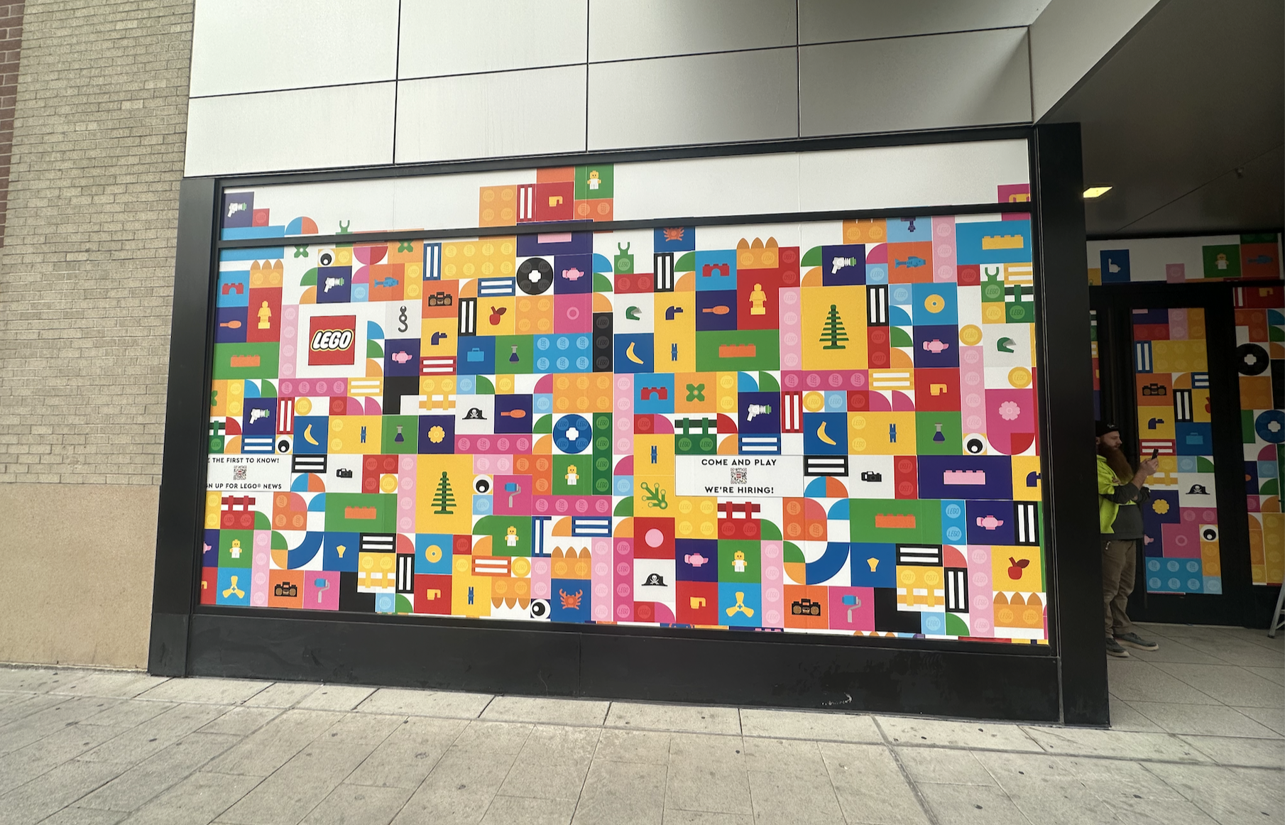 Colorful LEGO store advertisement with various LEGO brick illustrations and text inviting people to join and work at LEGO.