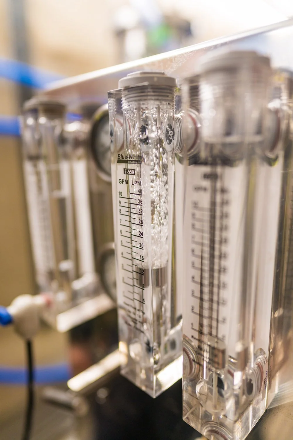 Close-up view of a syrup flow meter with several similar devices in the background. Milestone Ridge Maple Syrup - Pure Ontario maple syrup from Palmerston, Ontario, Canada. Grade A maple syrup available for purchase in golden maple syrup, amber maple
