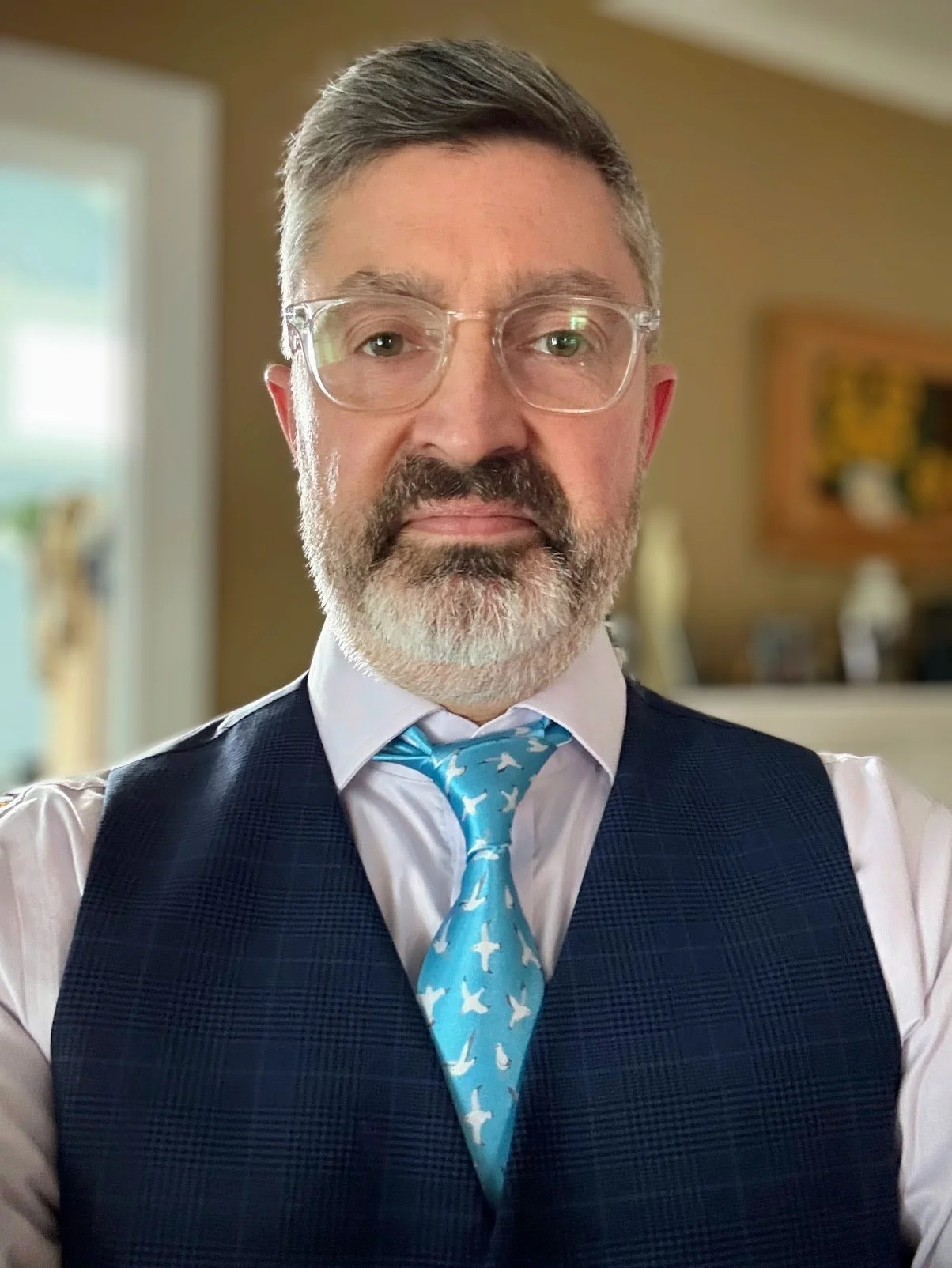 Greg Hoobler, wearing a vest, dress shirt, and tie with a seagull print