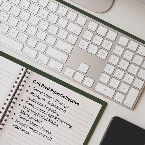 A computer keyboard, a notepad with a business strategy outline, and a smartphone on a desk.