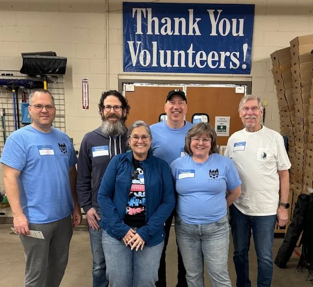 Six DGS volunteers at Arc Value Village with Thank You Volunteers sign