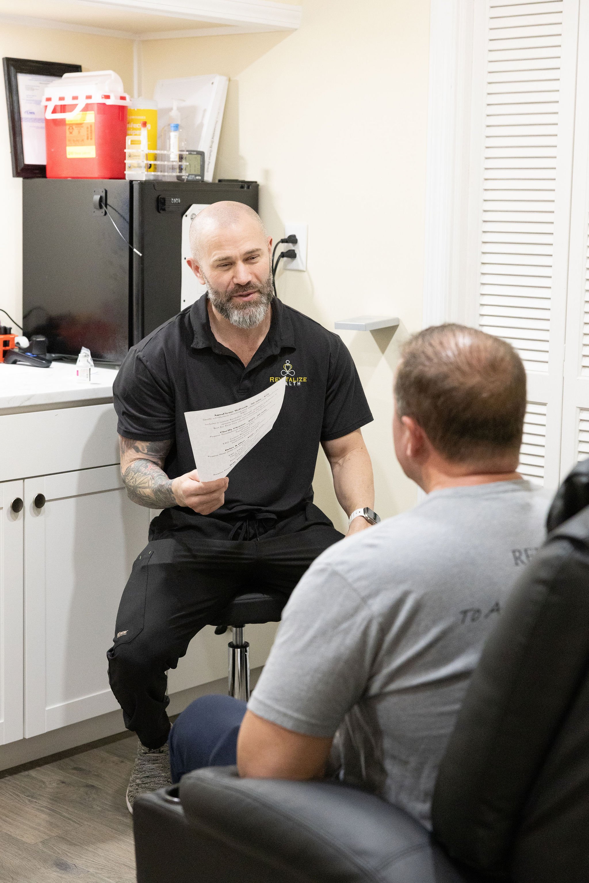 Expert medical aesthetic and weight loss provider at Revitalize Health in Florence conducting a client consult.