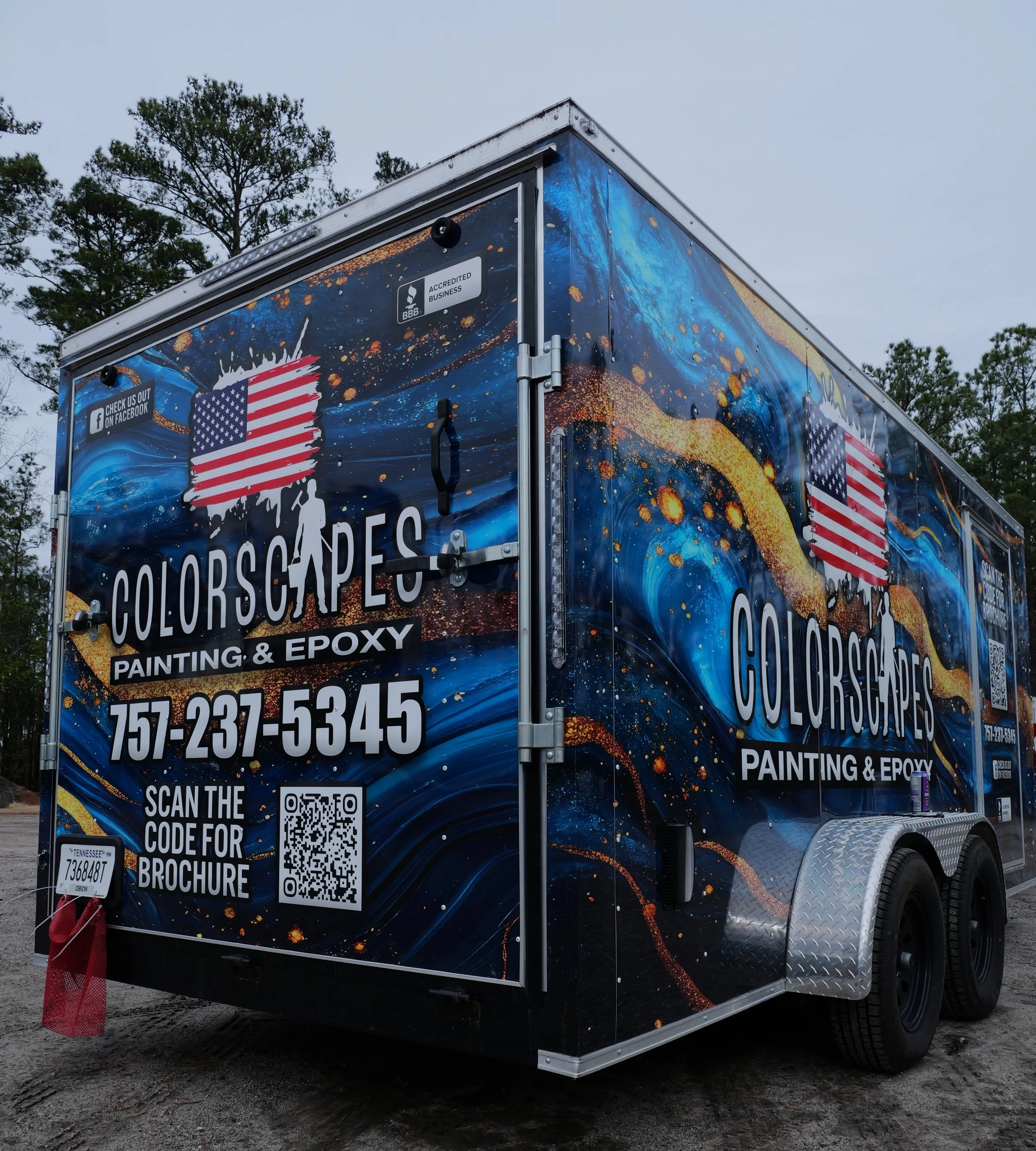 A colorful mobile trailer advertising Colorscapes Painting & Epoxy, featuring a blue and gold abstract paint splash design, with contact phone number 757-237-5345, a QR code, social media info, and an American flag logo.