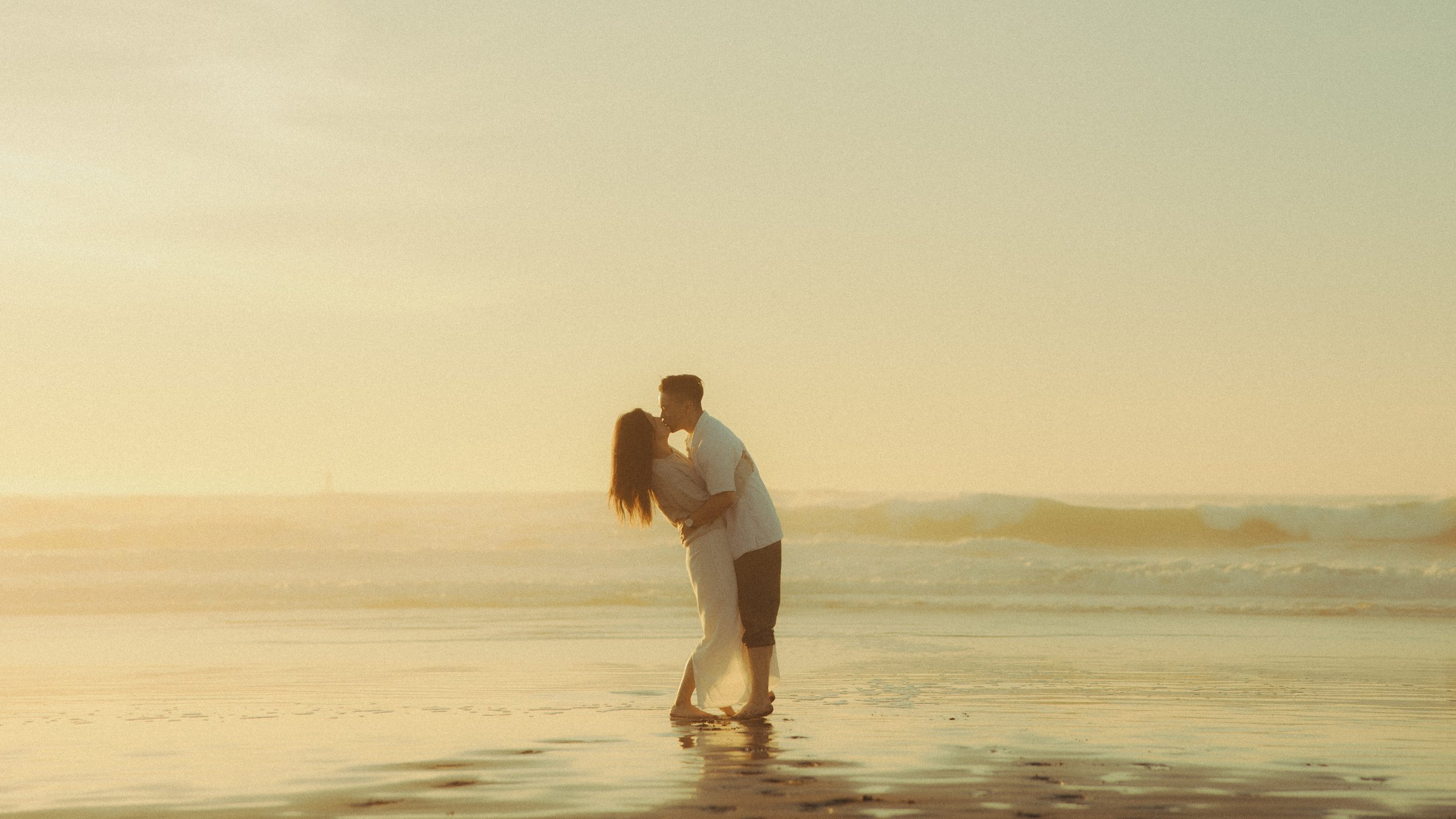 Oahu beach couples photography in shallow water at sunset