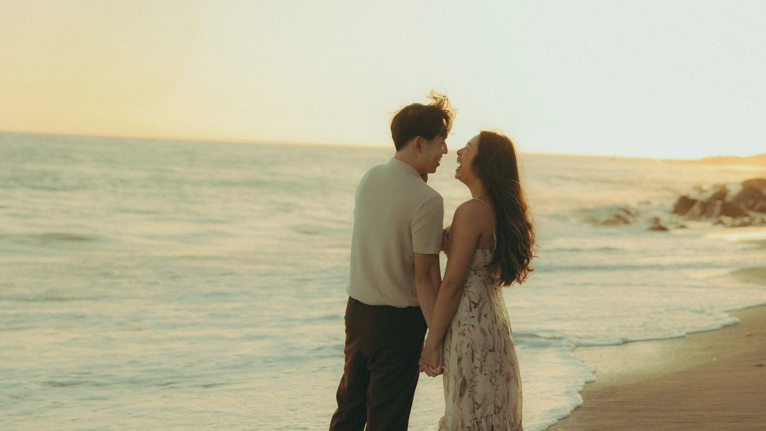 Oahu beach engagement session near rocks