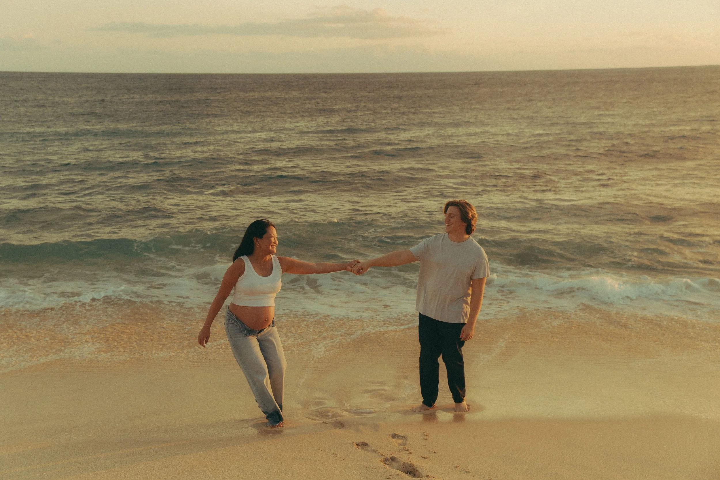 Oahu maternity photography holding hands at sunset
