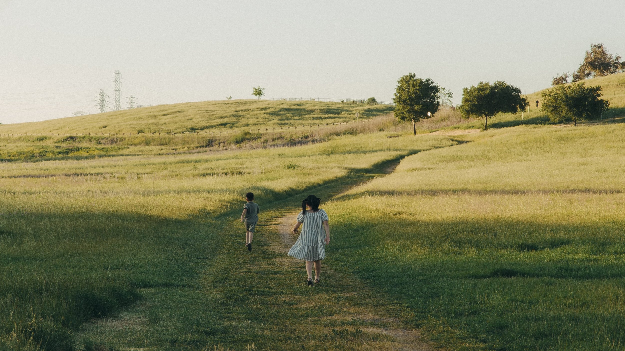 Oahu children walking through grassy countryside