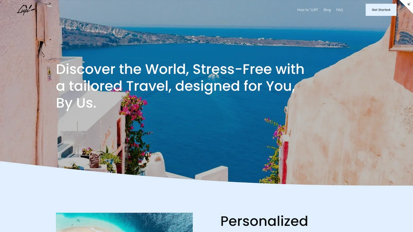 A scenic view of a coastline with a calm blue sea, mountains, and a cliffside in the distance, seen from a terrace with pink and white buildings and colorful flowers.