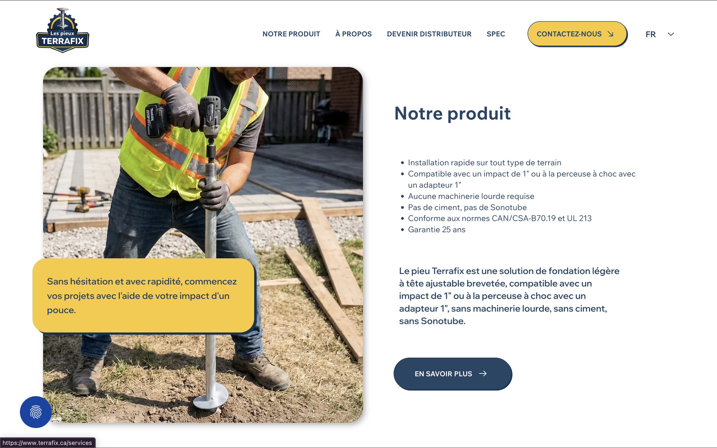 A man in a safety vest and gloves using a power tool to install a foundation pier on a construction site with wooden frames on the ground.
